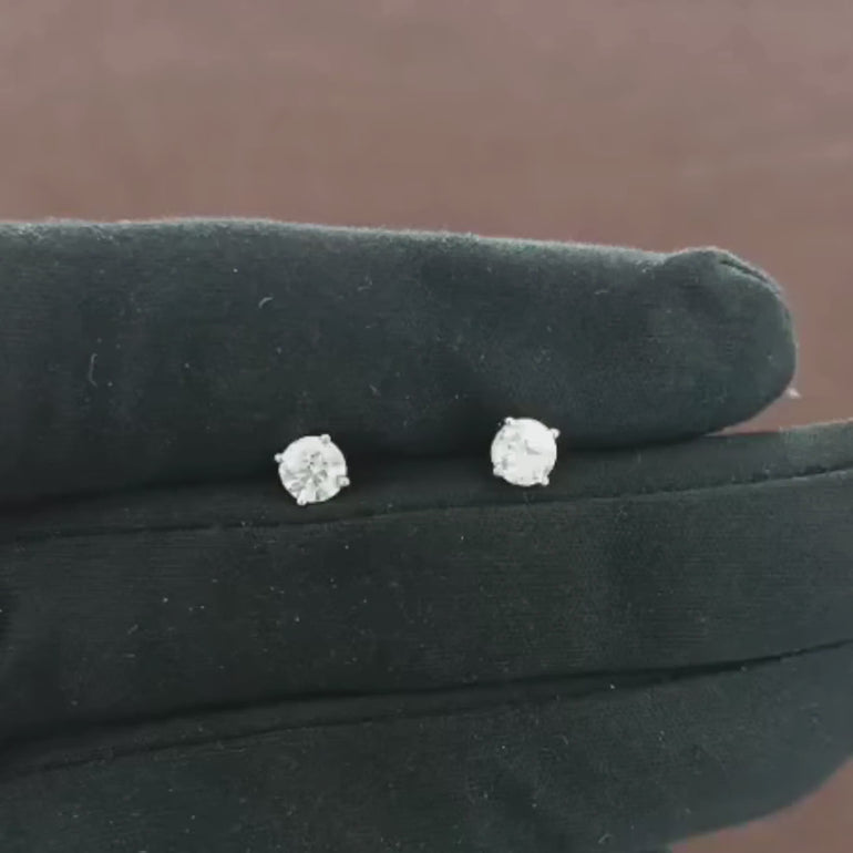 Video showcasing 0.68 CT natural round cut diamond stud earrings set in 18kt white gold, featuring timeless elegance and brilliant sparkle. 