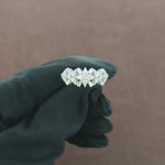 Load and play video in Gallery viewer, Video showcasing the  view of a 0.80 carat natural round and tapered baguette cut diamond ring set in 18kt white gold, highlighting the elegant profile and detailed diamond arrangement.

