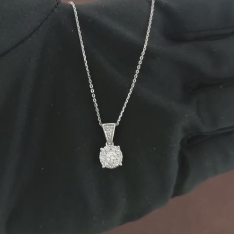 Video showcasing the 0.34 CT natural round cut diamond pendant set in 18kt white gold, highlighting its elegant design and the brilliant sparkle of the diamond in a close-up view.