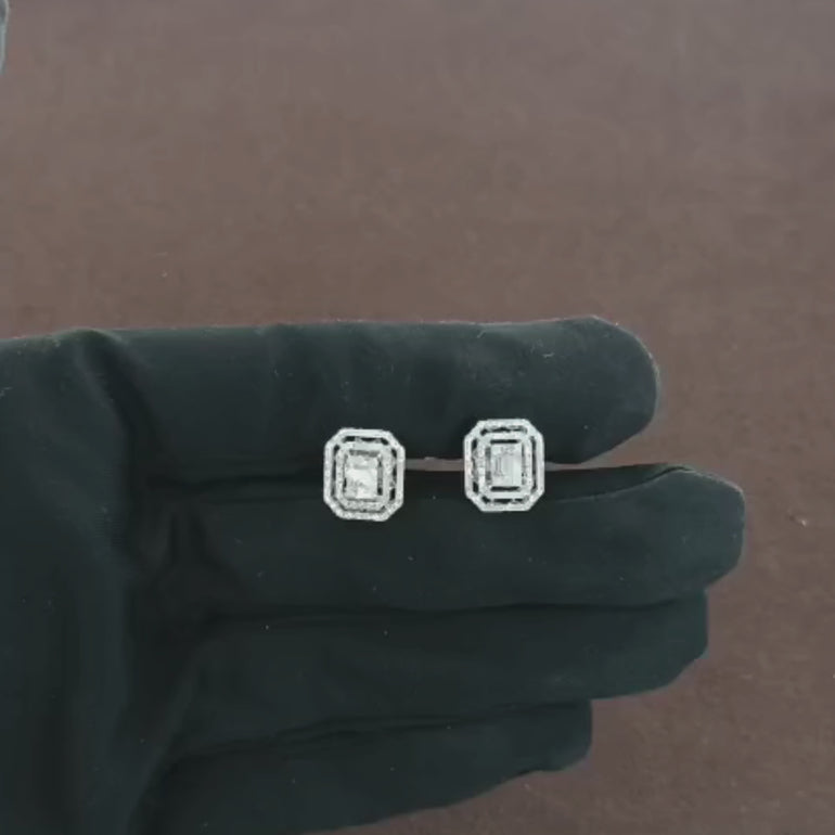 Video showcasing 0.69 CT natural round, straight baguette, and tapered baguette cut diamond stud earrings, highlighting the combination of diamond shapes in a sleek, sophisticated design.