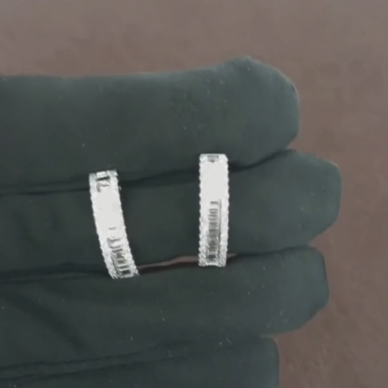 Video showcasing the 1.12 CT natural round and straight baguette cut diamond hoop earrings set in 18kt white gold, highlighting their elegant design and brilliant diamond sparkle in motion.