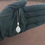 Load and play video in Gallery viewer, Video showcasing the 0.85 CT natural princess, tapered baguette, and round cut diamond pendant in 18kt white gold, emphasizing its elegant design, sparkling diamonds, and refined craftsmanship.
