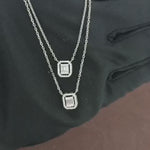 Load and play video in Gallery viewer, Video showcasing the 0.40 CT natural round and straight baguette cut diamond pendant set in 18kt white gold, highlighting the elegant design and the brilliant sparkle of the round and baguette diamonds in a detailed view.
