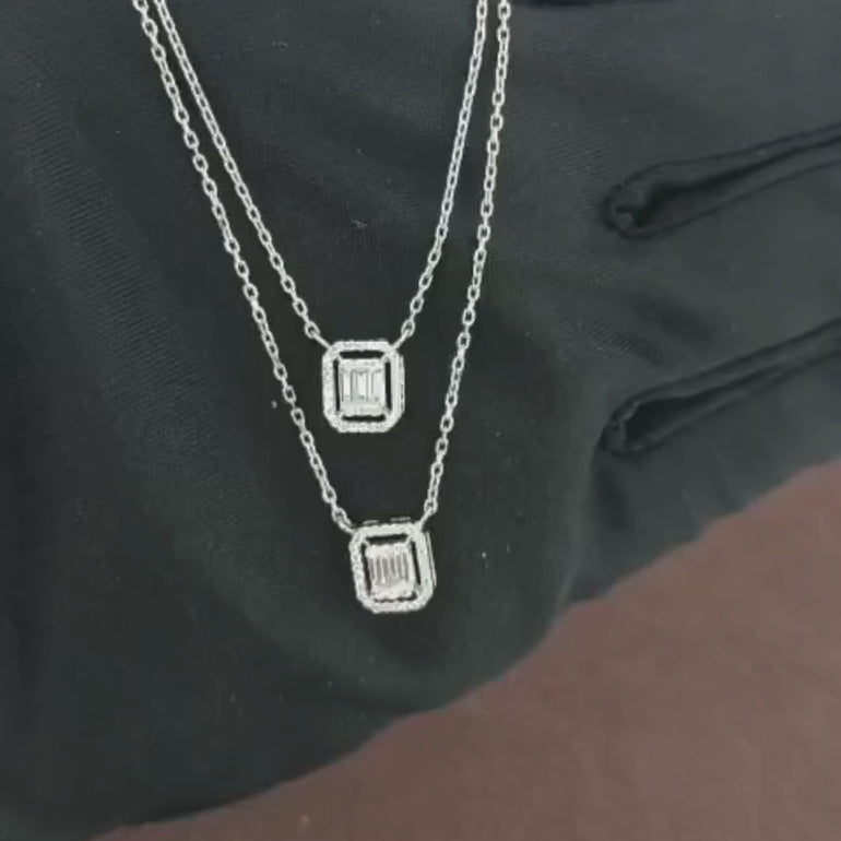 Video showcasing the 0.40 CT natural round and straight baguette cut diamond pendant set in 18kt white gold, highlighting the elegant design and the brilliant sparkle of the round and baguette diamonds in a detailed view.