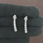 Load and play video in Gallery viewer, Video showcasing the 1.37 CT natural round cut diamond tennis earrings set in 18kt white gold, highlighting their elegant design and brilliant diamond sparkle.
