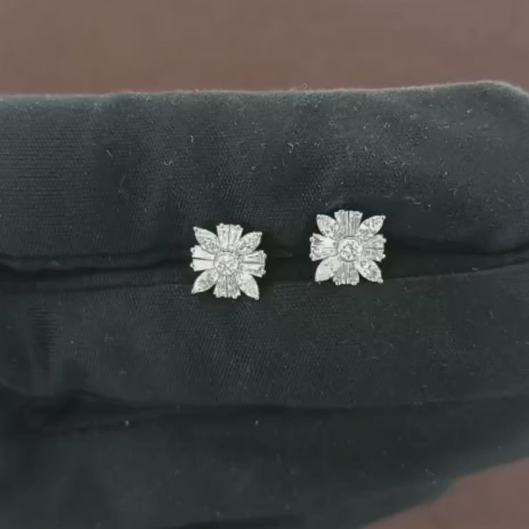 Video showcasing the 0.78 CT natural round, marquise cut, and tapered baguette cut diamond stud earrings set in 18kt white gold, highlighting their exquisite design and sparkling diamonds.